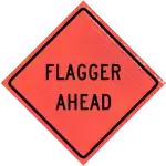 flagger ahead warning sign for road work